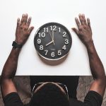 round silver colored wall clock